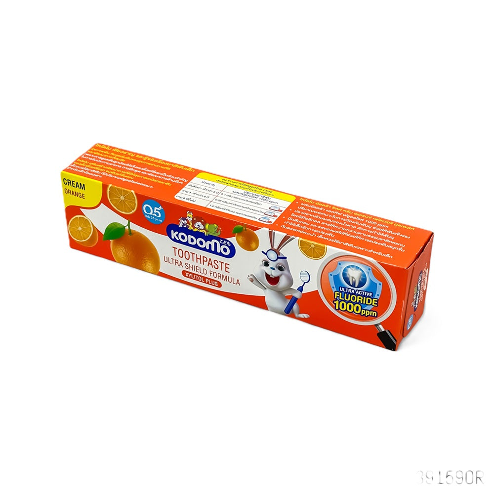 Kodomo Orange Cream Toothpaste for kids with Ultra Shield Formula, fluoride protection, and Xylitol in fun orange-flavored packaging.