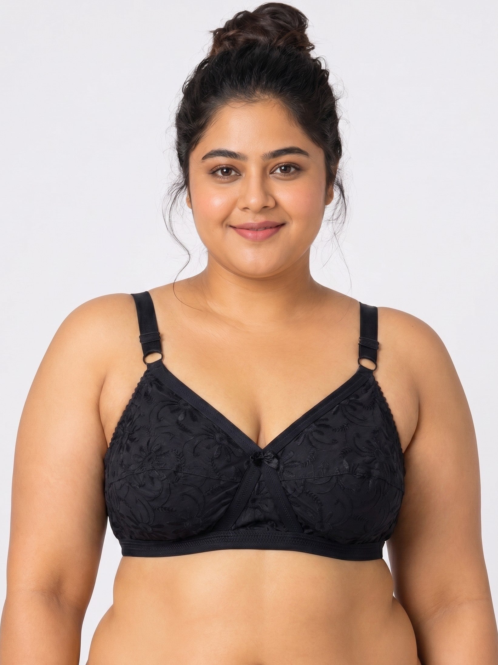 Woman wearing a black lace bra against a white background #color_black