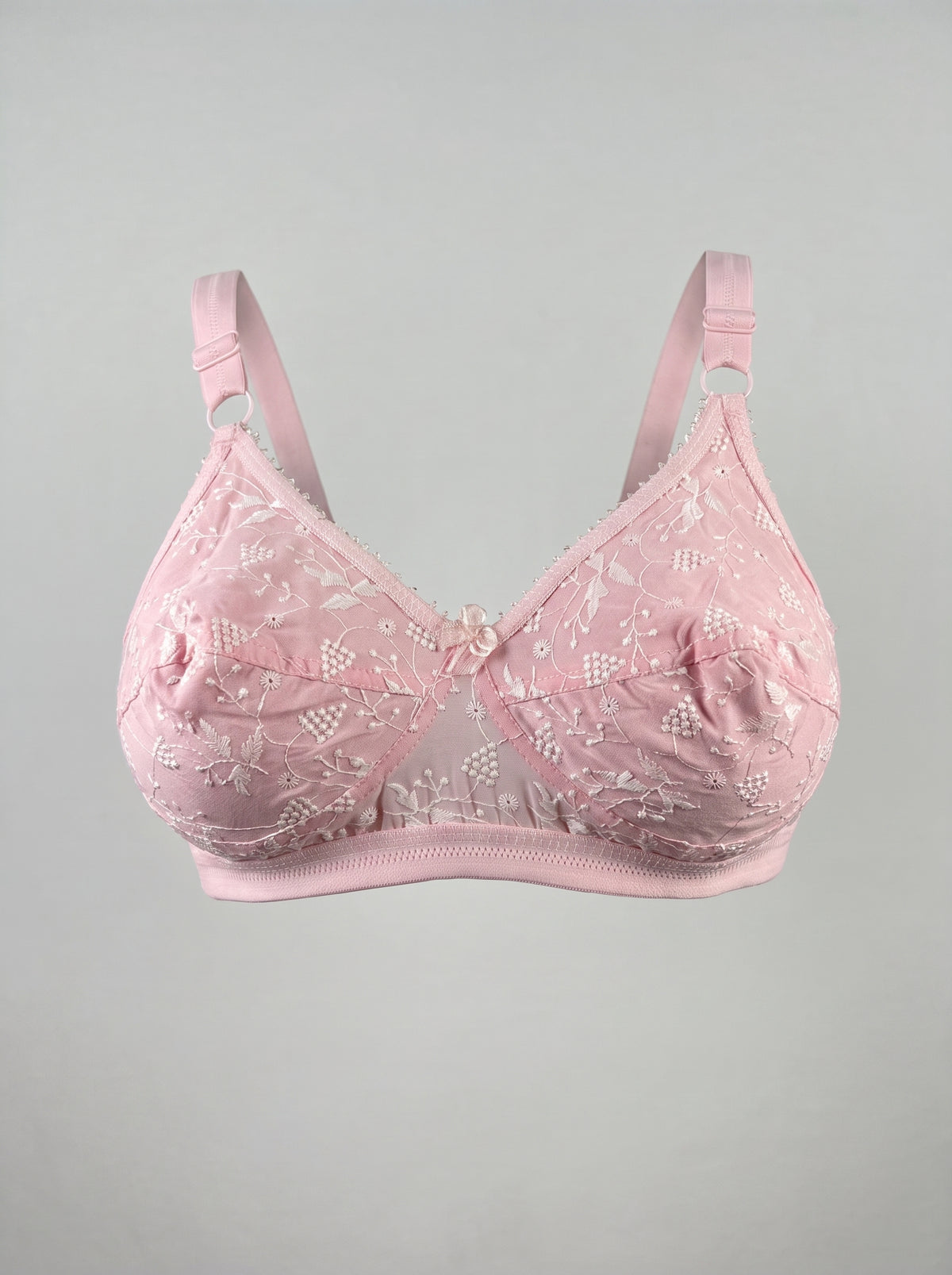 Like-Me Sonu Bra in pink with floral lace cups, center bow and adjustable straps, ghost mannequin front view. #color_pink