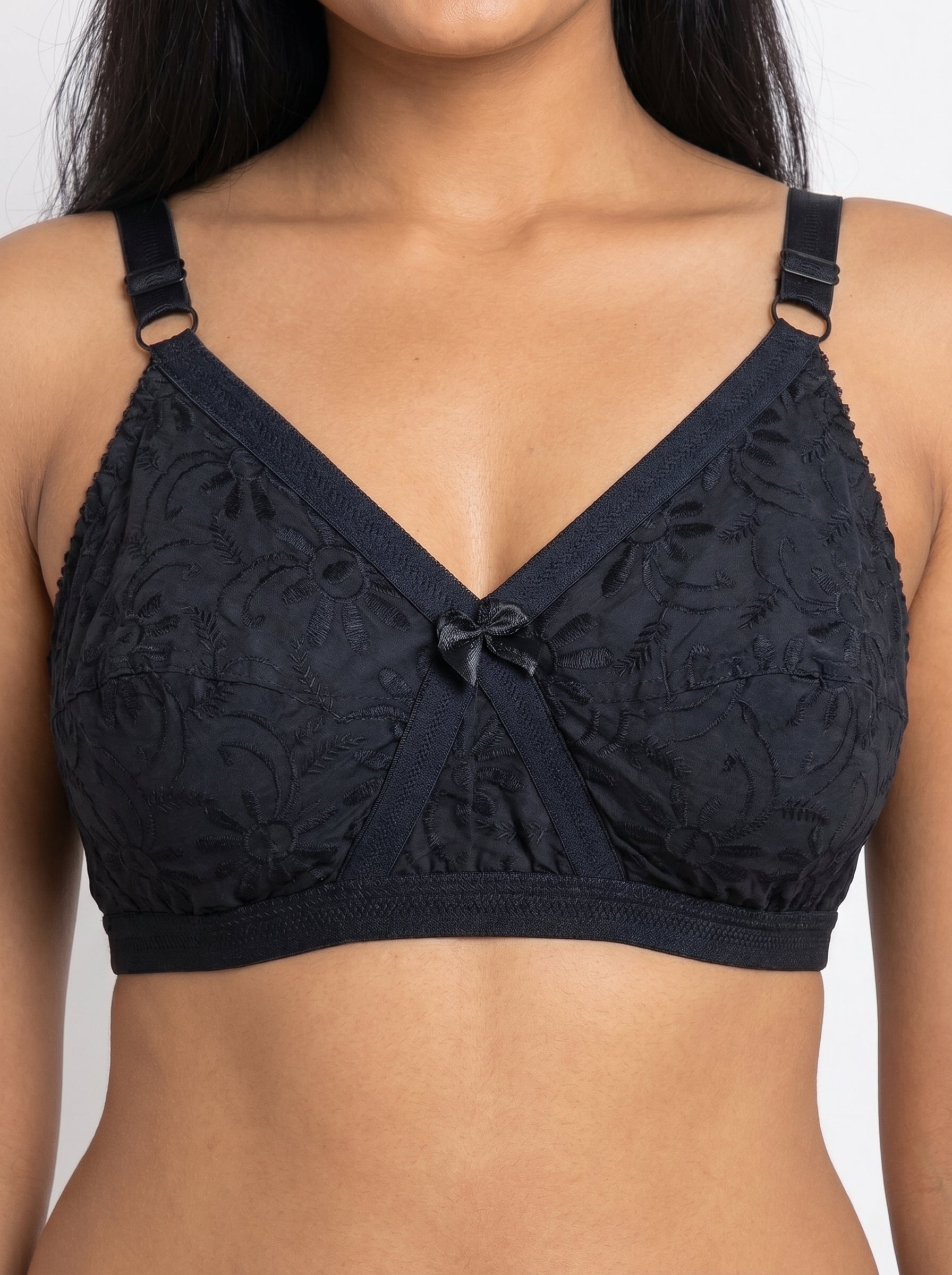 Black lace bra on a model against a neutral background #color_black