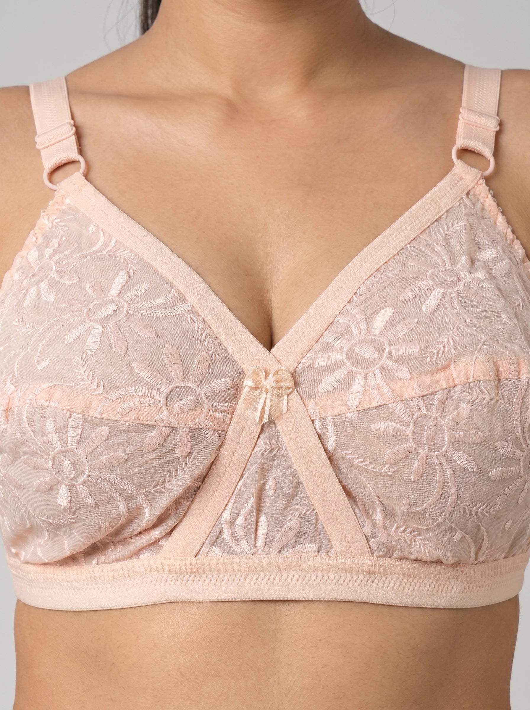 Light pink lace bra on a neutral background #color_peach