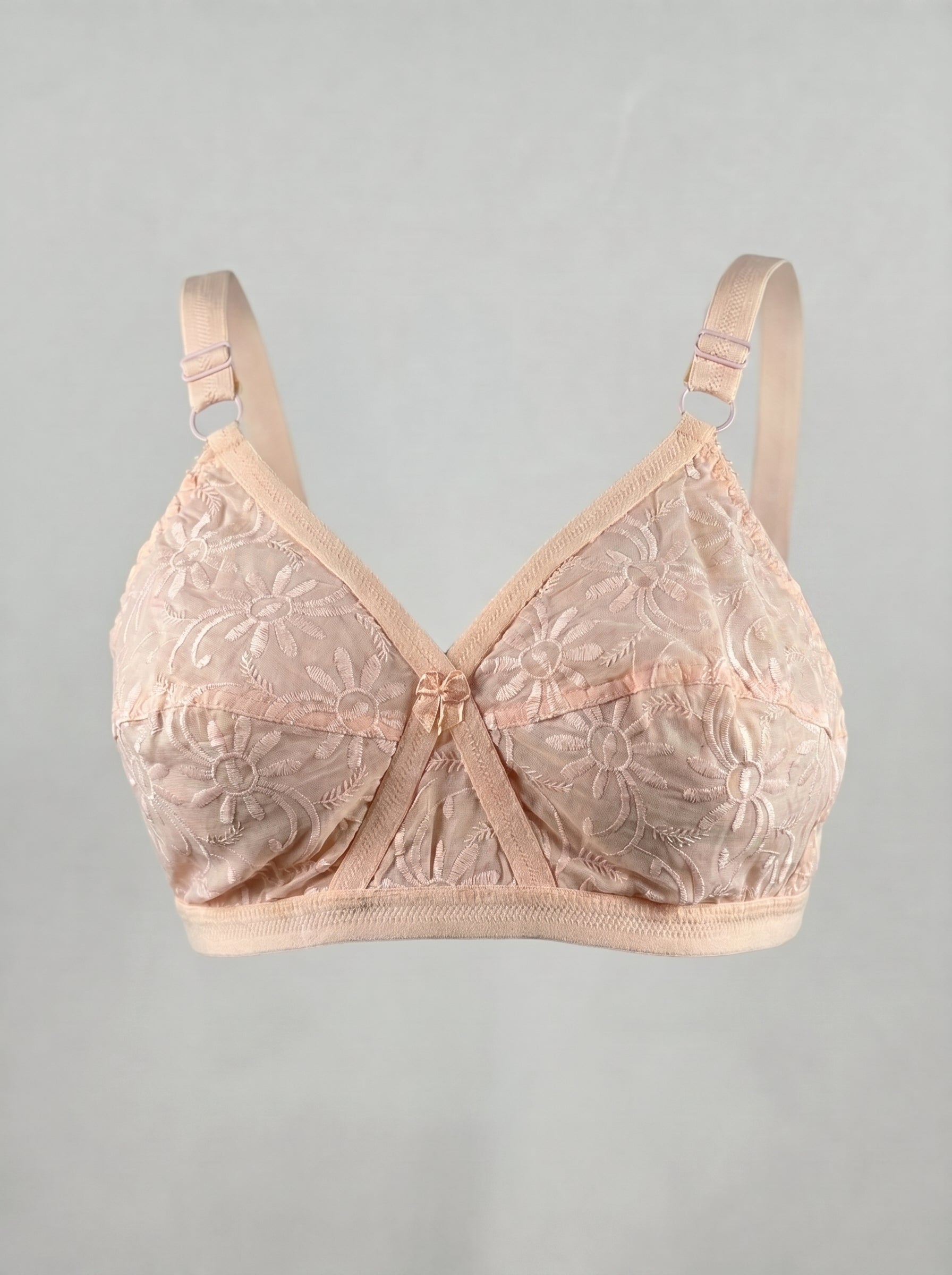 Pink bra with floral lace details on a gray background #color_peach
