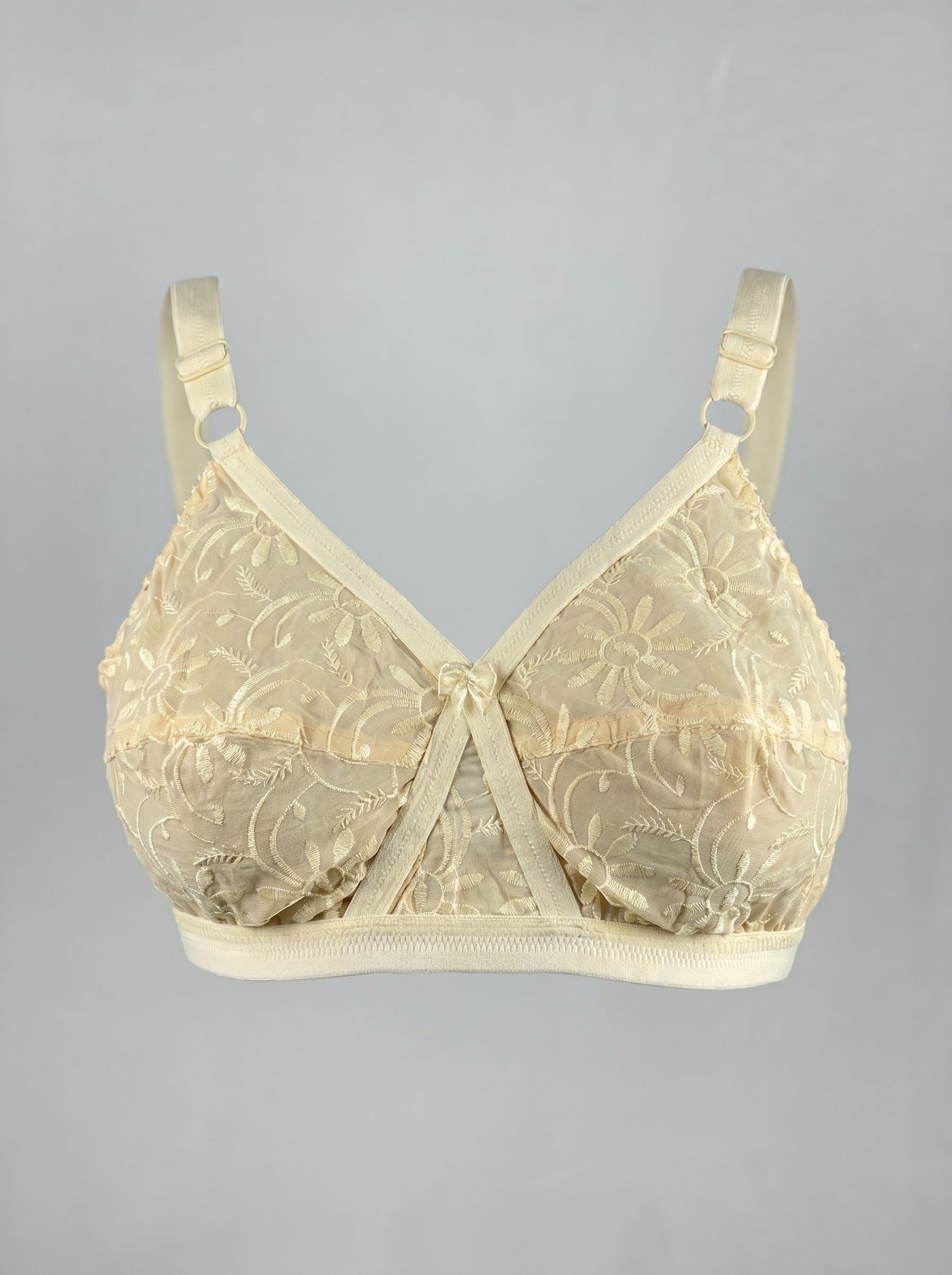 Beige lace bra on a gray background #color_skin