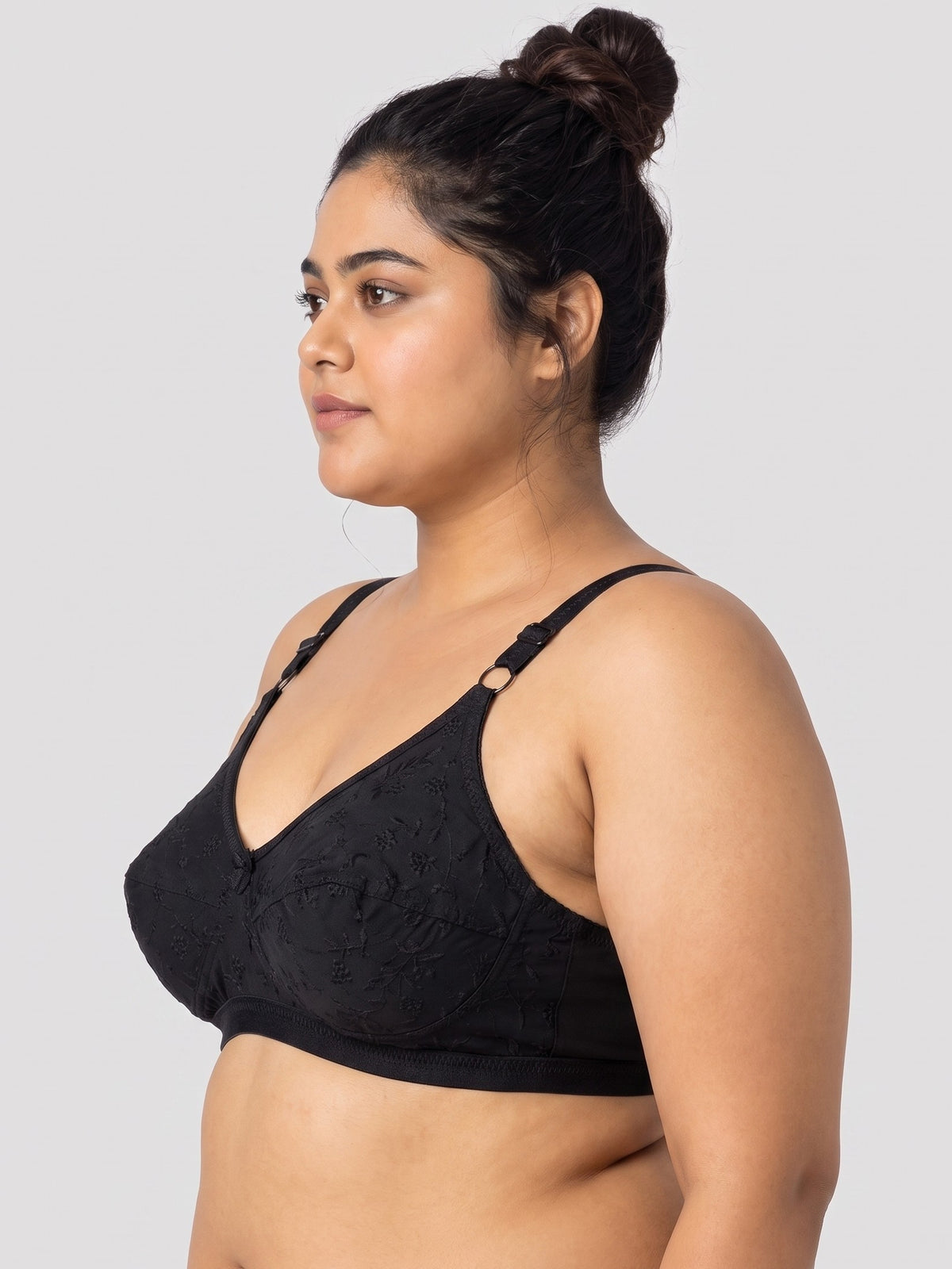 Like-Me Sonu Bra in black with floral lace cups and adjustable straps, side view on plus-size model. #color_black