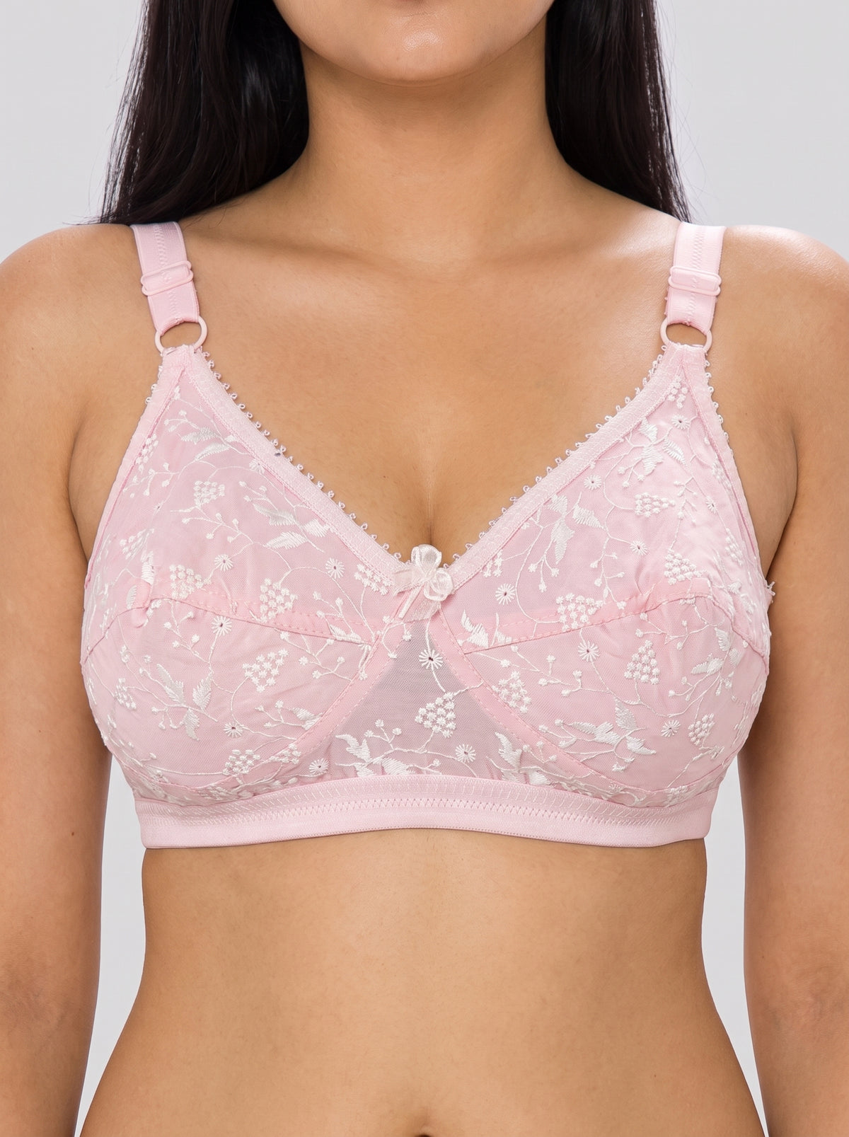 Close-up of Like-Me Sonu Bra in pink featuring floral lace cups, center bow and supportive underband. #color_pink