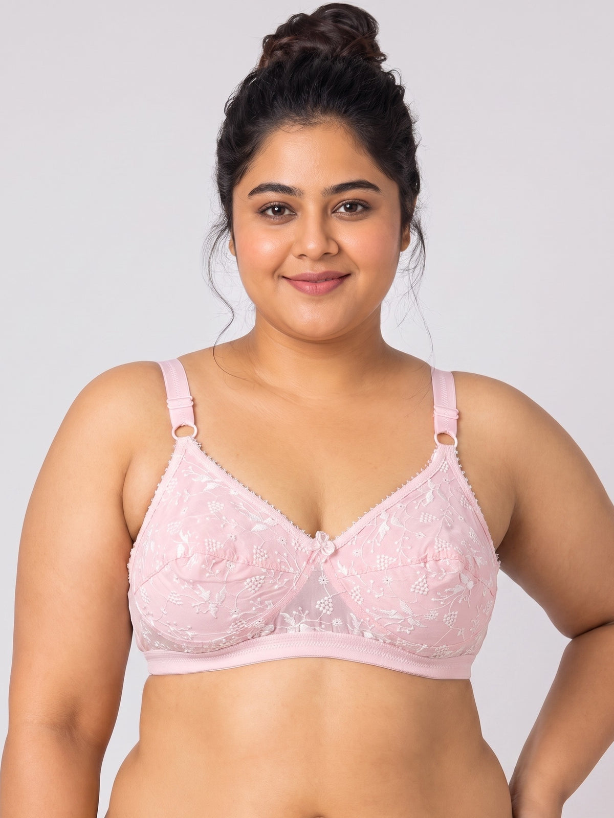 Like-Me Sonu Bra in pink with floral lace cups, center bow and adjustable straps, front view on plus-size model. #color_pink