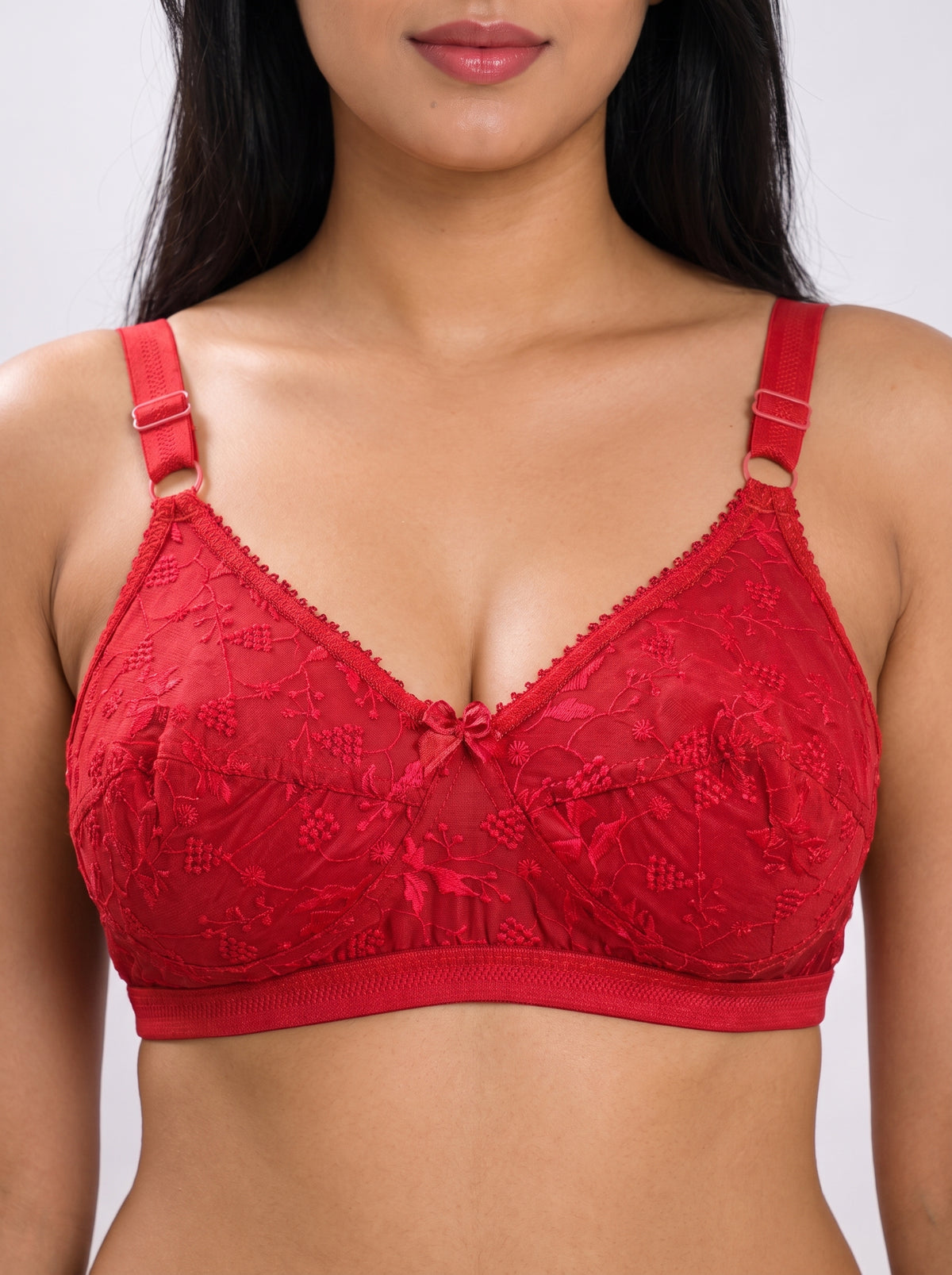 Close-up of Like-Me Sonu Bra in red featuring floral lace cups, center bow and adjustable straps. #color_red