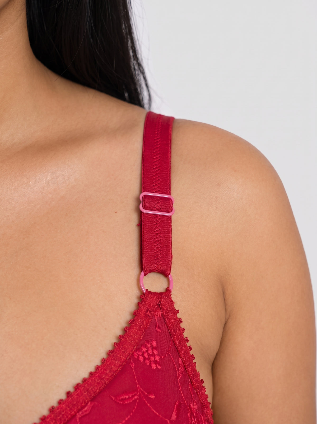 Close-up of Like-Me Sonu Bra in red showing adjustable shoulder strap and ring detail. #color_red