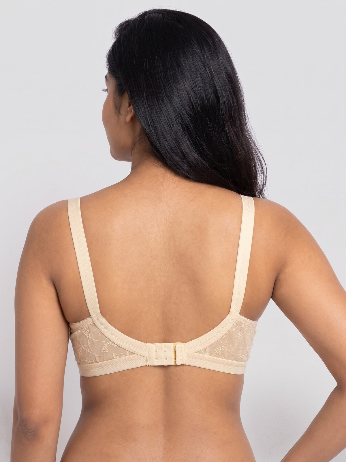 Like-Me Sonu Bra in skin color with adjustable straps and hook-and-eye back closure, back view on model. #color_skin